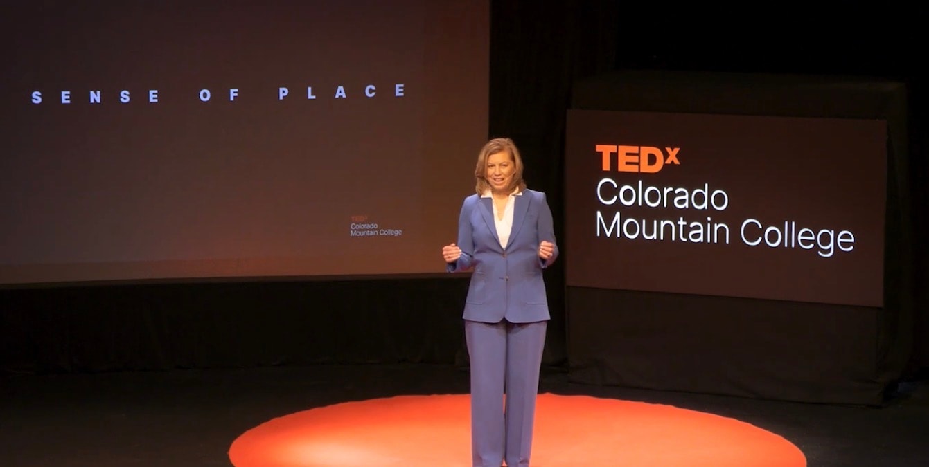 Mary Mason delivering a TEDx presentation onstage